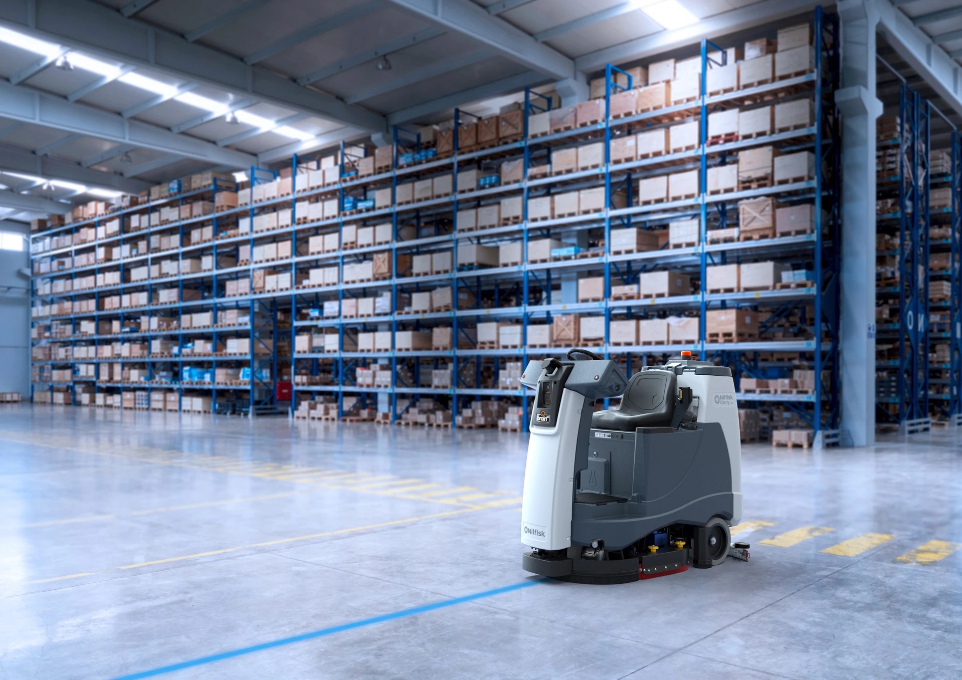Nilfisk Liberty SC60 autonomous floor scrubber cleaning a warehouse aisle between tall pallet racks