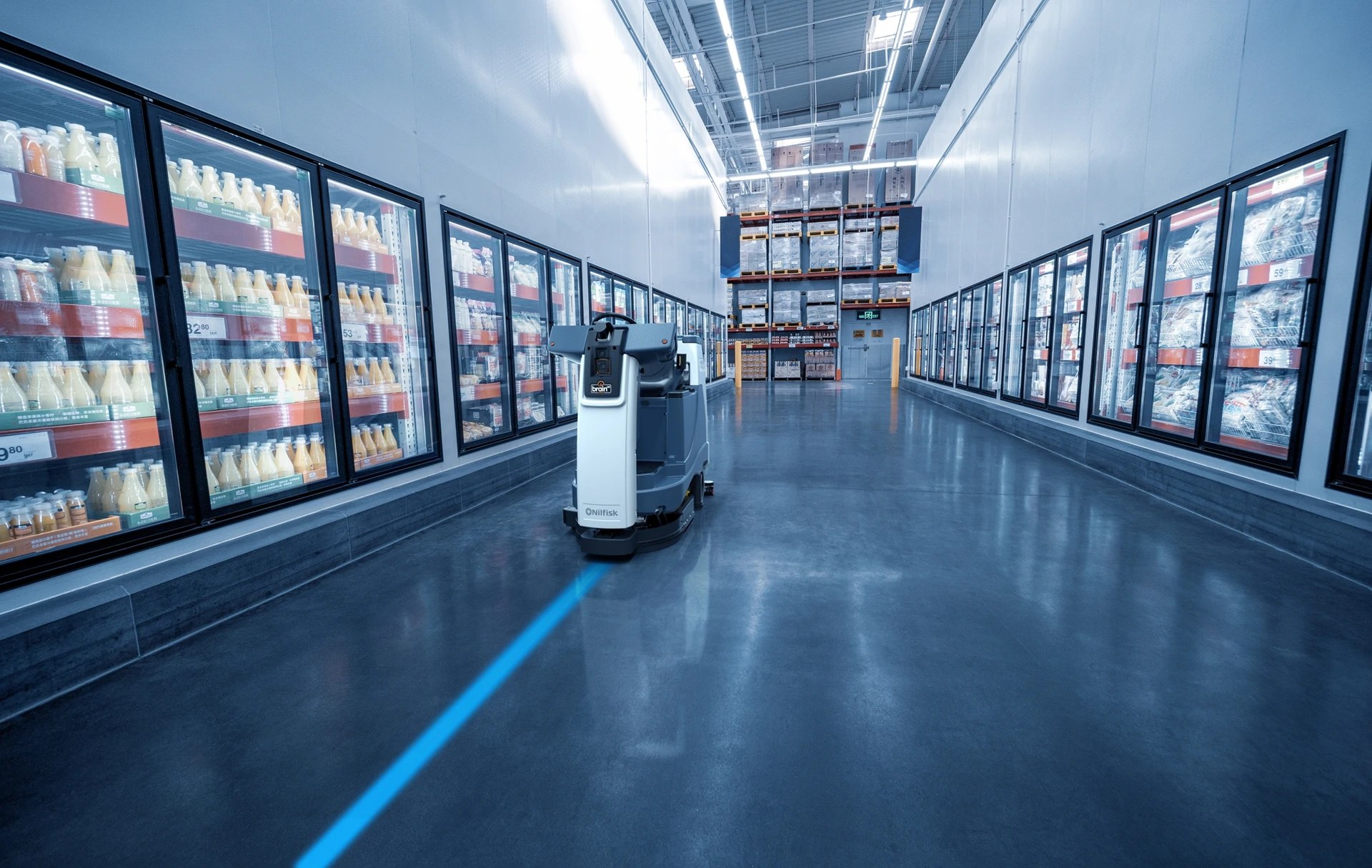 Nilfisk Liberty SC60 robotic scrubber cleaning a grocery store freezer aisle on its own