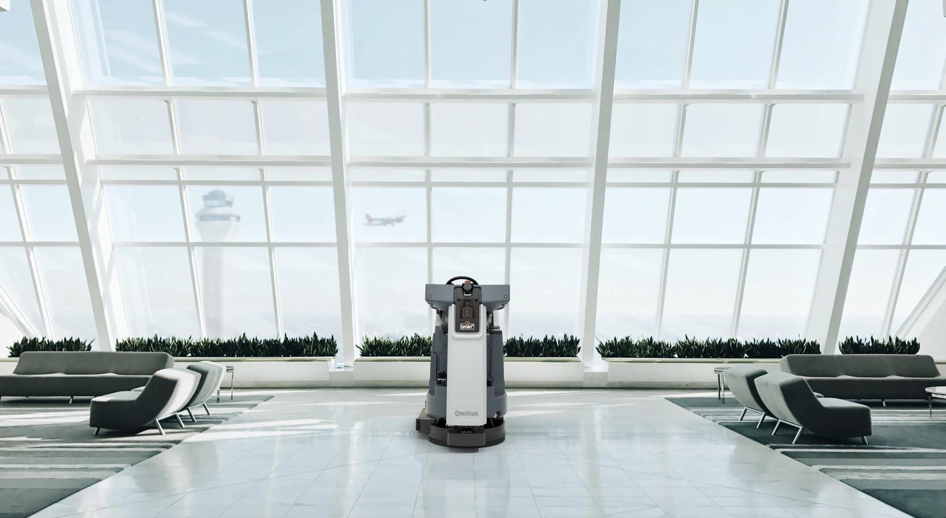 Nilfisk Liberty SC60 robotic floor scrubber working in an open airport terminal