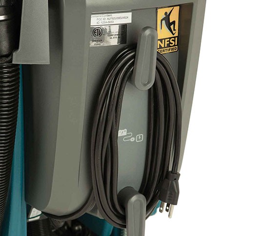 On-board charger power cord stored on hooks at the back of a Tennant T300-series scrubber