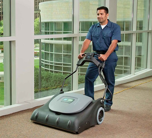 Operator vacuuming a carpeted lobby with the Tennant V-WA-30