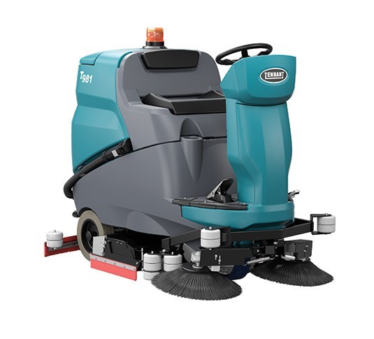 Tennant T981 cylindrical ride-on floor scrubber, front right view showing the seat, steering column and sweeping side brushes