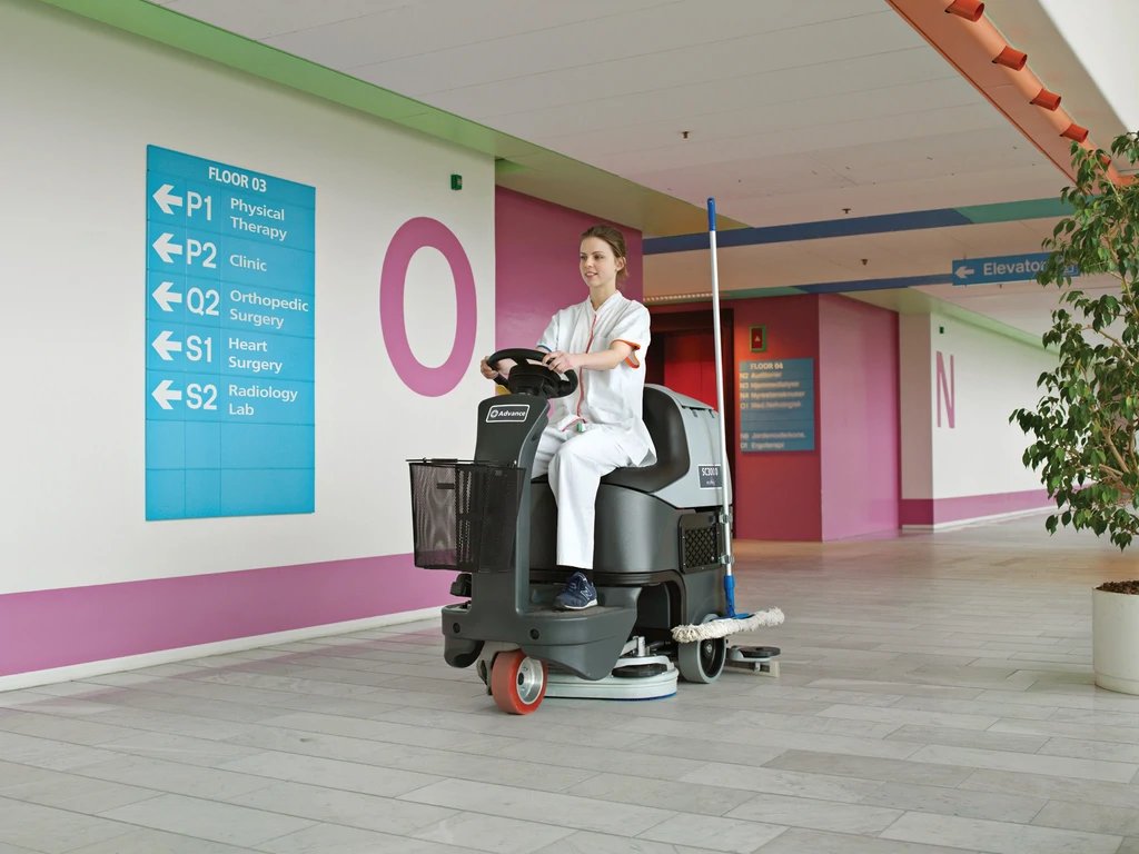 Operator riding an Advance SC3000 scrubber in a hospital corridor