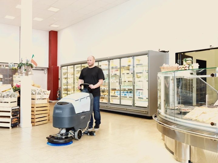 Advance SC401 floor scrubber cleaning in front of a grocery store deli counter