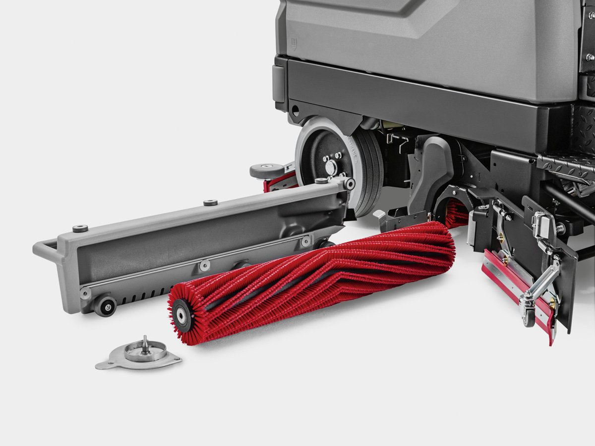 Close-up of the red cylindrical roller brush sliding out of the B 260 RI scrub deck