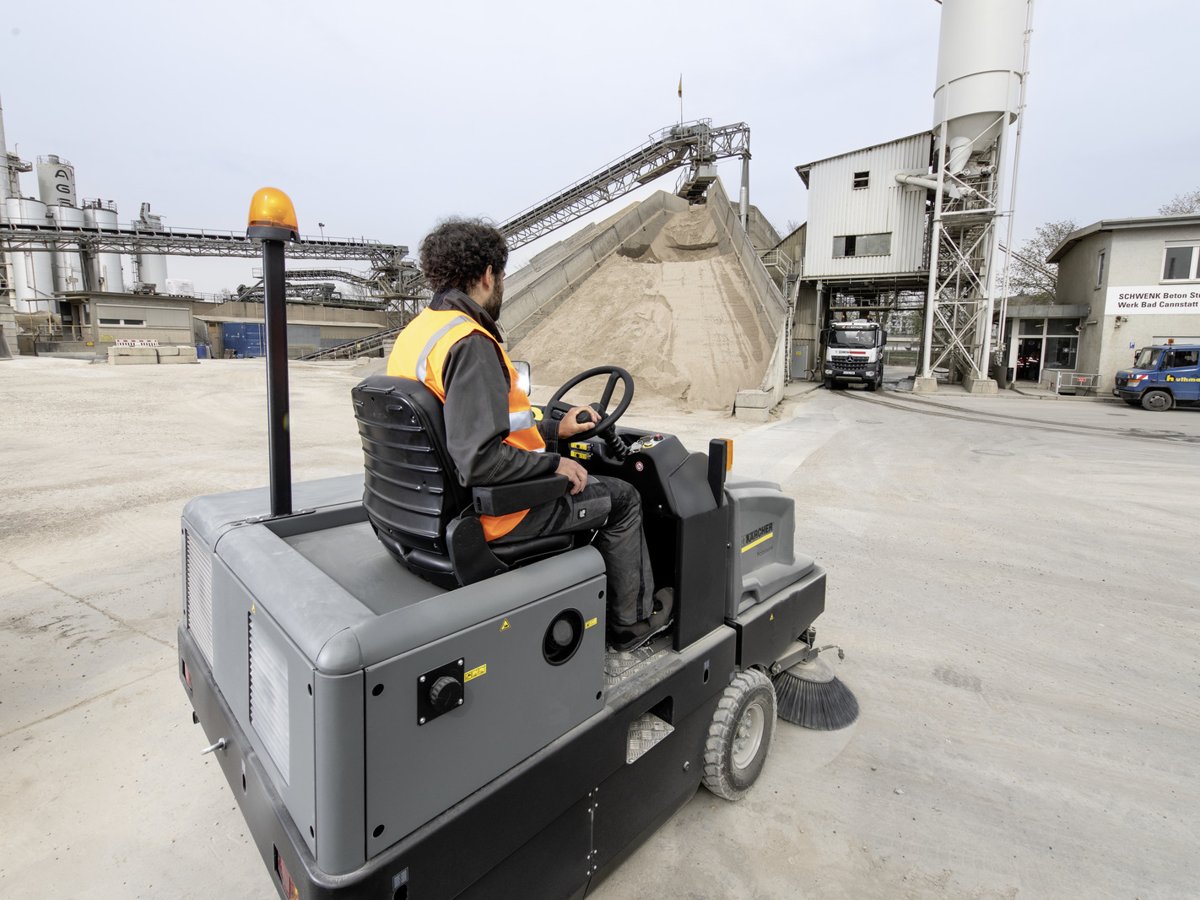 Operator sweeping a concrete plant yard with the Kärcher KM 150/500 R