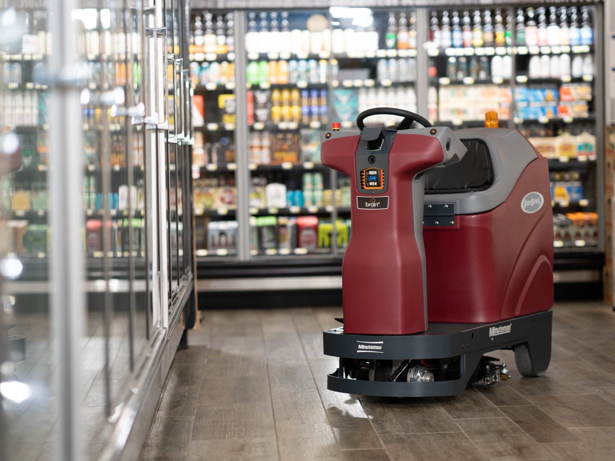 Minuteman RoboScrub 20 autonomous scrubber cleaning a grocery store aisle