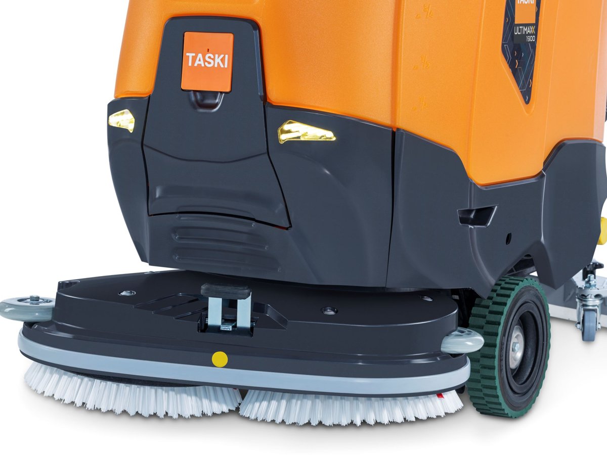 Close-up of the TASKI ULTIMAXX 1900 DD55 double disc brush deck and wheels