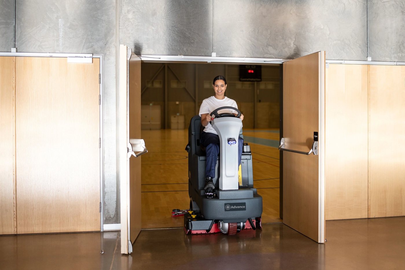 Advance SC4000 rider scrubber driving through a standard doorway