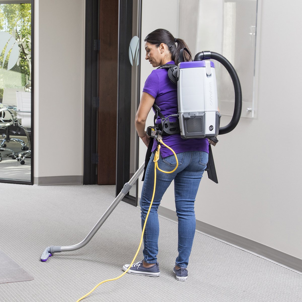 ProTeam Super Coach Pro 6 backpack vacuum in use on carpet